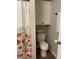 Bathroom featuring a toilet with storage and a decorative shower curtain at 1540 Roanoke Dr, Zionsville, IN 46077