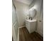 Bathroom featuring a modern vanity, stylish lighting, and a glass-enclosed shower at 1540 Roanoke Dr, Zionsville, IN 46077