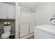 Shower room with a frosted glass door and white cabinets for storage at 1540 Roanoke Dr, Zionsville, IN 46077