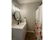 Bathroom featuring a modern vanity with stylish lighting and decorative floral shower curtain at 1540 Roanoke Dr, Zionsville, IN 46077