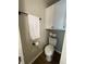 Cozy powder room featuring storage cabinet, toilet and a decorative towel rack at 1540 Roanoke Dr, Zionsville, IN 46077