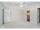 Bright bedroom featuring neutral walls, ceiling fan, carpet and easy access to an ensuite bathroom and walk-in closet at 1540 Roanoke Dr, Zionsville, IN 46077
