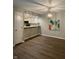 Dining room with wood-look floors, stylish light fixture, and open to the kitchen at 1540 Roanoke Dr, Zionsville, IN 46077