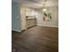 Dining room with wood-look floors, stylish light fixture, and open to the kitchen at 1540 Roanoke Dr, Zionsville, IN 46077