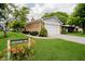 Charming brick home featuring an attached two-car garage and well-manicured lawn at 1540 Roanoke Dr, Zionsville, IN 46077