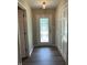 Bright foyer featuring wood-look floors, closet for storage, and a front door with decorative glass at 1540 Roanoke Dr, Zionsville, IN 46077