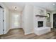 Bright foyer featuring wood-look flooring, a fireplace, and a glass front door at 1540 Roanoke Dr, Zionsville, IN 46077