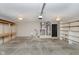 Spacious garage with room for two cars, storage shelves and workspace at 1540 Roanoke Dr, Zionsville, IN 46077
