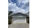 Garage featuring white garage door with gray trim and brick exterior at 1540 Roanoke Dr, Zionsville, IN 46077