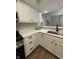 Bright eat-in kitchen featuring stainless steel appliances, white cabinets, and hardwood floors at 1540 Roanoke Dr, Zionsville, IN 46077