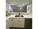 Well-lit kitchen area with a stainless steel sink, quartz counters, and white cabinetry at 1540 Roanoke Dr, Zionsville, IN 46077