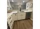 Well-lit kitchen area with a stainless steel sink, quartz counters, and white cabinetry at 1540 Roanoke Dr, Zionsville, IN 46077
