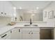 Bright kitchen featuring white cabinets, quartz countertops, stainless steel dishwasher, and open layout at 1540 Roanoke Dr, Zionsville, IN 46077