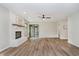 Bright living area with a fireplace, ceiling fan, and sliding doors to the outside at 1540 Roanoke Dr, Zionsville, IN 46077