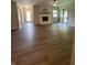 Open-concept living room with wood flooring, fireplace, and sliding glass doors to the exterior at 1540 Roanoke Dr, Zionsville, IN 46077
