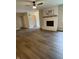 Open-concept living room featuring a cozy fireplace, wood-look floors, and abundant natural light at 1540 Roanoke Dr, Zionsville, IN 46077