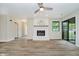 Spacious living room featuring a fireplace, sliding glass doors, and wood-look flooring at 1540 Roanoke Dr, Zionsville, IN 46077