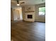 Bright living room featuring a cozy fireplace, wood-look floors, and abundant natural light at 1540 Roanoke Dr, Zionsville, IN 46077
