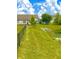 View of the home's backyard featuring a pond, green grass, and partial fencing at 1688 Magnolia Dr, Greenwood, IN 46143