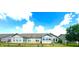 Spacious backyard featuring a brick home with large windows, a cozy patio, and a well-manicured lawn at 1688 Magnolia Dr, Greenwood, IN 46143