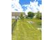 View of the home's backyard featuring a pond, green grass, and partial fencing at 1688 Magnolia Dr, Greenwood, IN 46143