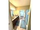 Well-lit bathroom featuring a double sink vanity, and a view into the adjacent bedroom at 1688 Magnolia Dr, Greenwood, IN 46143