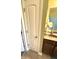 Neat bathroom featuring a well-lit vanity, tiled floor, and a linen closet offering practical storage solutions at 1688 Magnolia Dr, Greenwood, IN 46143