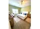 Bright bedroom with neutral carpet, ceiling fan, large window, and stylish furnishings at 1688 Magnolia Dr, Greenwood, IN 46143