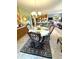 Formal dining room boasts a chandelier and elegant furnishings, with an open view to the kitchen at 1688 Magnolia Dr, Greenwood, IN 46143