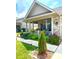 Charming home featuring a covered front porch with flower boxes and beautifully landscaped garden at 1688 Magnolia Dr, Greenwood, IN 46143