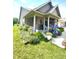 Attractive home featuring a cozy, covered porch with colorful flowers and beautifully landscaped garden at 1688 Magnolia Dr, Greenwood, IN 46143