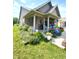Attractive home featuring a cozy, covered porch with colorful flowers and beautifully landscaped garden at 1688 Magnolia Dr, Greenwood, IN 46143