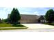 Beautiful brick home featuring a three-car garage, well-maintained lawn, and established landscaping at 1688 Magnolia Dr, Greenwood, IN 46143