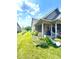 Charming home featuring a covered front porch with flower boxes and a beautifully landscaped garden at 1688 Magnolia Dr, Greenwood, IN 46143