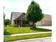 Charming brick home features a manicured lawn, lovely landscaping, and an attached three-car garage at 1688 Magnolia Dr, Greenwood, IN 46143