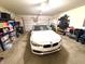 Spacious garage with overhead lighting provides ample room for parking and storage on shelving at 1688 Magnolia Dr, Greenwood, IN 46143