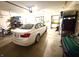 Spacious garage featuring a white car, ample storage shelving, and a well-organized interior at 1688 Magnolia Dr, Greenwood, IN 46143