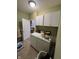 Functional laundry room with white cabinets, washer and dryer, and access to additional storage at 1688 Magnolia Dr, Greenwood, IN 46143