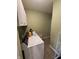 Well-lit laundry room with a white washer and dryer, upper cabinets, and tiled flooring at 1688 Magnolia Dr, Greenwood, IN 46143