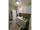 Functional laundry room with white cabinets, washer and dryer, and access to additional storage at 1688 Magnolia Dr, Greenwood, IN 46143