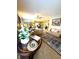 Open-concept living room with hardwood floors, stylish furniture, and seamless flow to the dining area at 1688 Magnolia Dr, Greenwood, IN 46143
