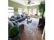 Bright and airy living room with comfortable seating, large windows, and tree in the corner at 1688 Magnolia Dr, Greenwood, IN 46143