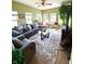 Bright and airy living room with comfortable seating, large windows, and tree in the corner at 1688 Magnolia Dr, Greenwood, IN 46143