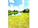 Serene view of a pond surrounded by lush greenery, providing a peaceful environment at 1688 Magnolia Dr, Greenwood, IN 46143