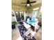 Bright sunroom with a glass table, white chairs, and a brick accent wall with sliding glass doors at 1688 Magnolia Dr, Greenwood, IN 46143