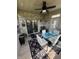 Cozy sunroom featuring a glass table, white chairs, and a brick accent wall with sliding glass doors at 1688 Magnolia Dr, Greenwood, IN 46143