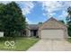 Charming brick ranch home with an attached two-car garage and lovely, mature landscaping at 17717 Cedarbrook Dr, Westfield, IN 46074