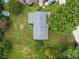 The aerial view of the home displays the roofline and how it sits amongst mature shade trees at 1841 Shady Ln, Martinsville, IN 46151