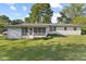 Back exterior featuring a porch and a large grass yard at 1841 Shady Ln, Martinsville, IN 46151