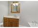 Bathroom featuring a vanity with wood cabinetry, neutral countertop, and square mirror at 1841 Shady Ln, Martinsville, IN 46151
